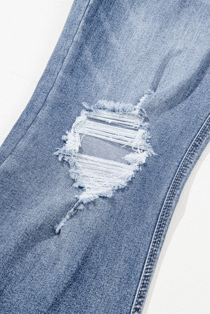 Dusk blue high-waisted flared jeans with distressed hem and ripped details