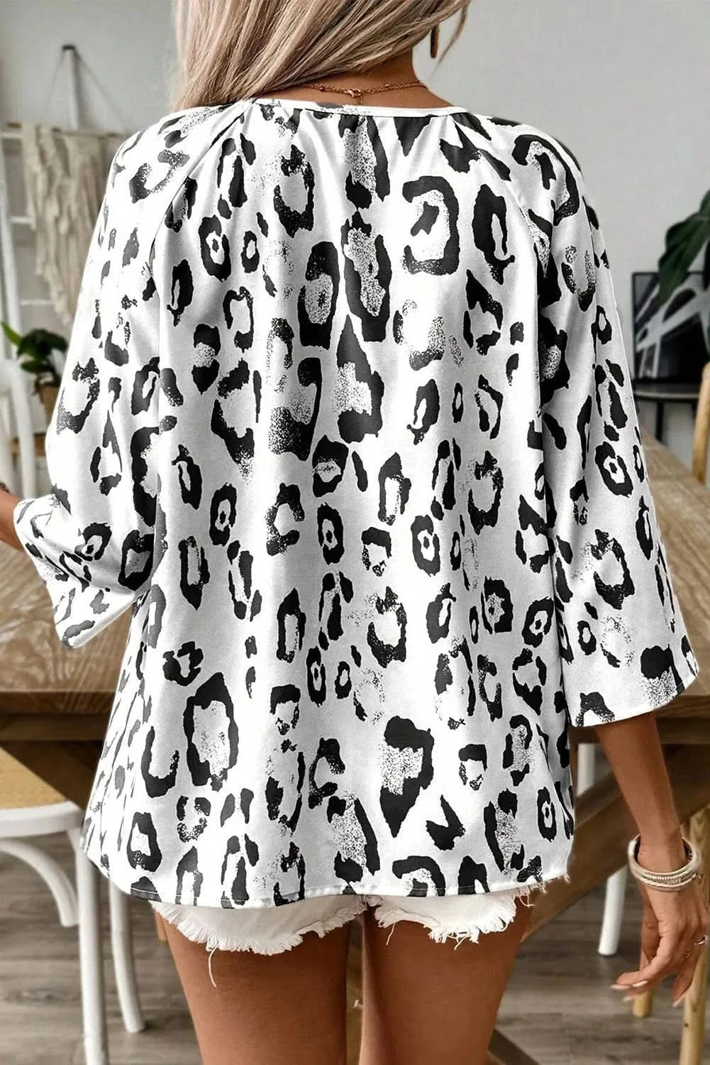 Leopard-print v-neck blouse with three-quarter sleeves