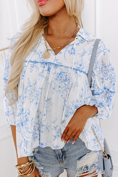 Chic sky blue floral blouse with tied collar and 3/4 sleeves