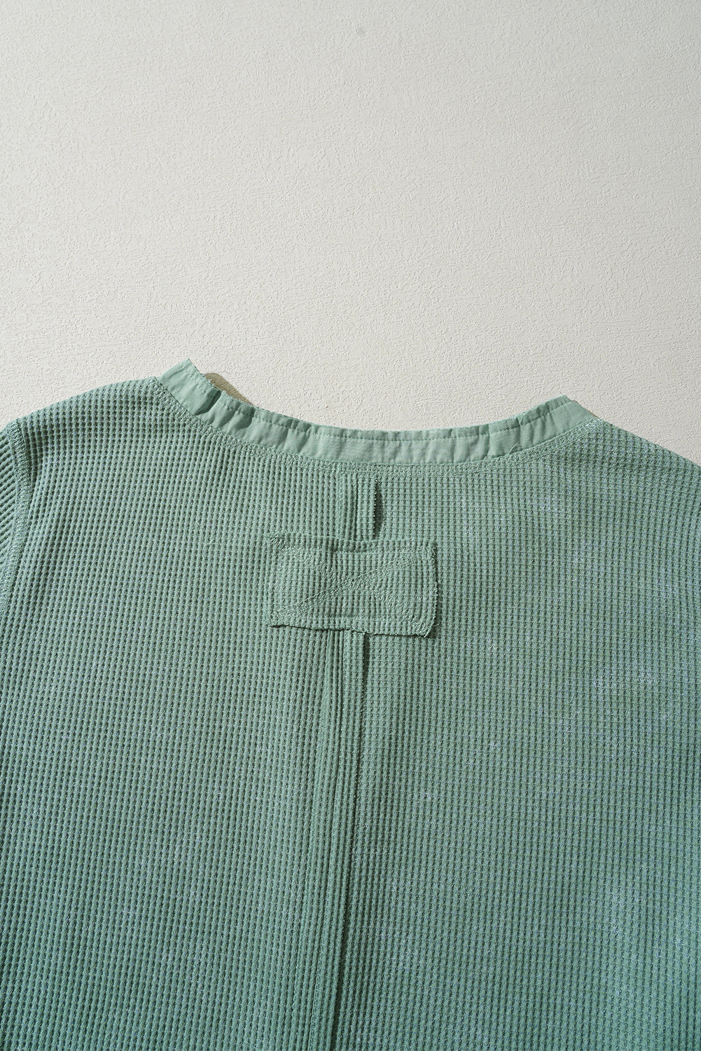 Trendy smoke green acid wash waffle knit long sleeve top with buttoned neckline