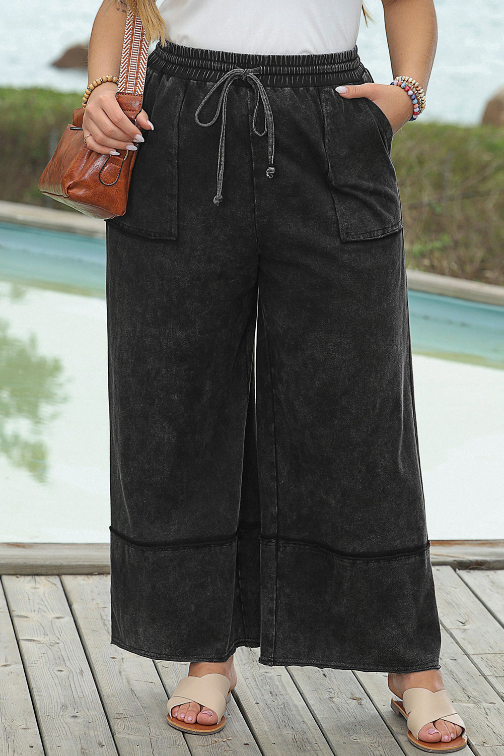 Chic black mineral wash wide leg cropped pants with exposed seams