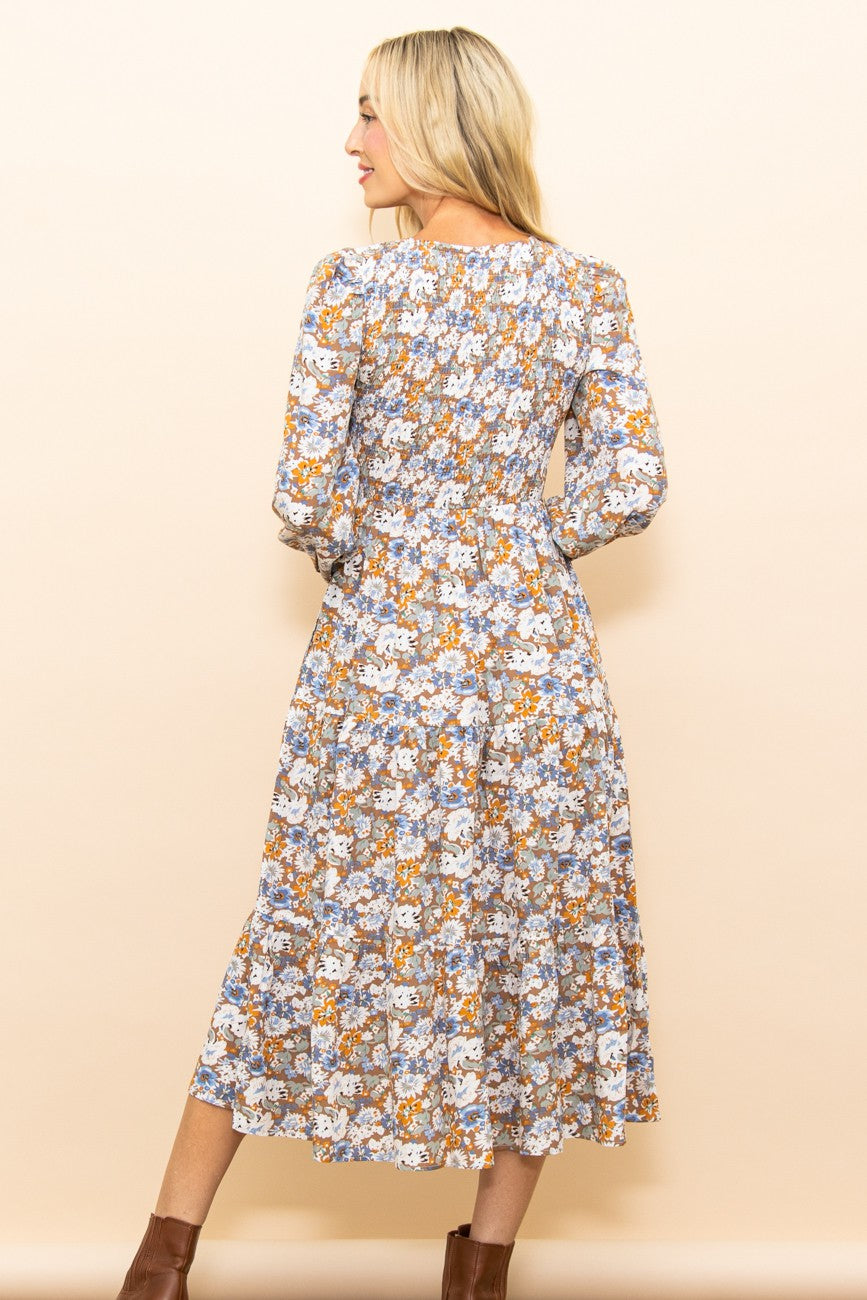 PinkBlush Taupe Floral Smocked Tiered Midi Dress shown in a lifestyle setting, showcasing the comfortable tiered skirt and pr