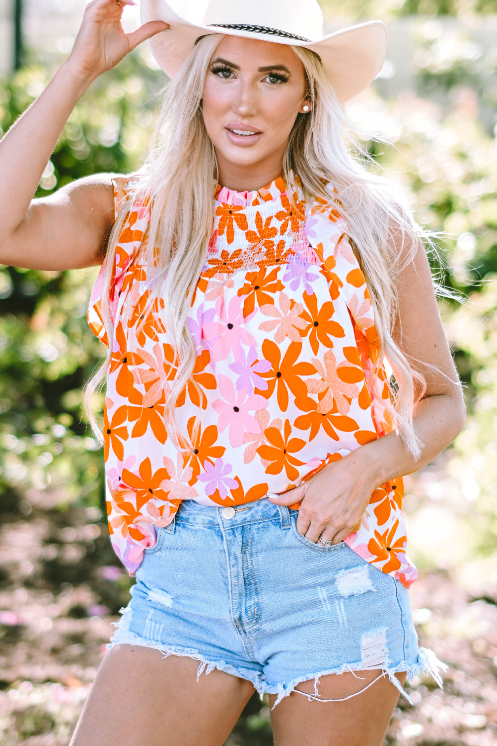 Floral delight: Orange ruffled sleeve top with smocked detail