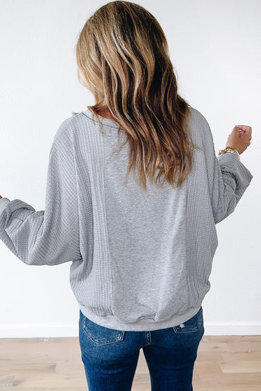 Chic light grey waffle patchwork pullover with raw hem details