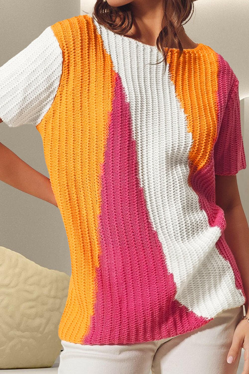 Color block round neck short sleeve knit top in orange, pink, and white.