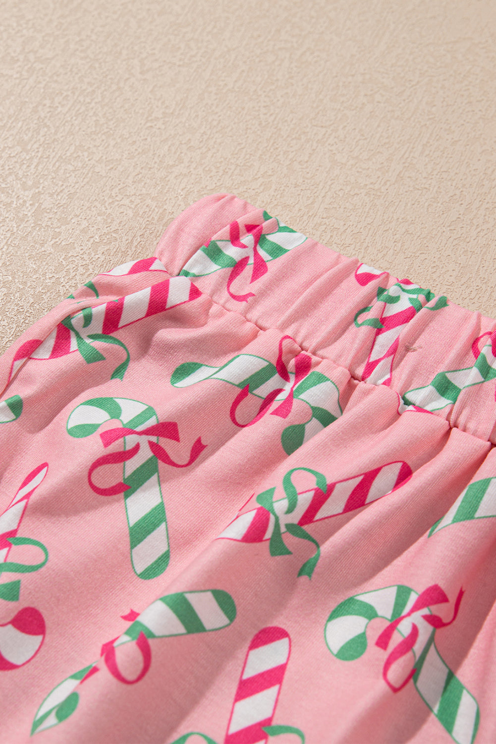 Festive pink candy cane print knotted pajama set with pockets