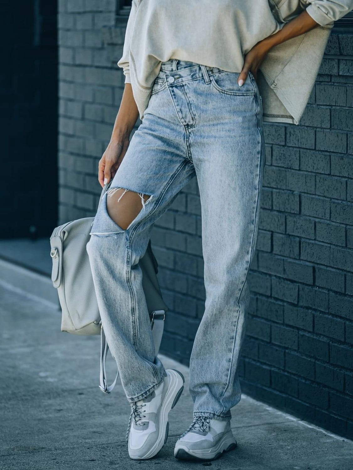 Distressed Asymmetric Waist Jeans.