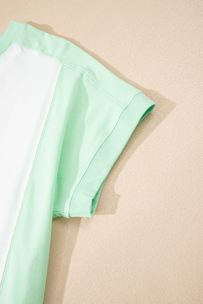 Light green color block exposed seam crew neck t-shirt with short sleeves.