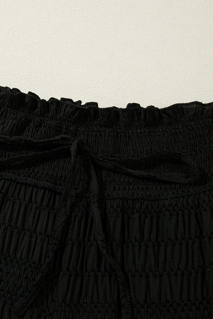 Relaxed black textured smocked waist wide-leg pants