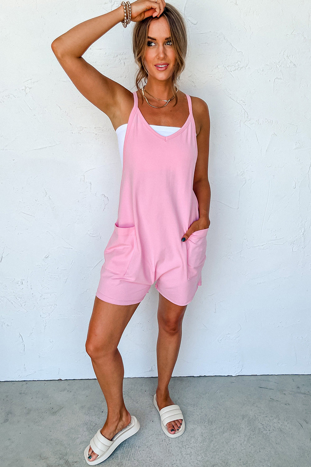 Chic pink sleeveless jersey romper with pockets and v-neck detail