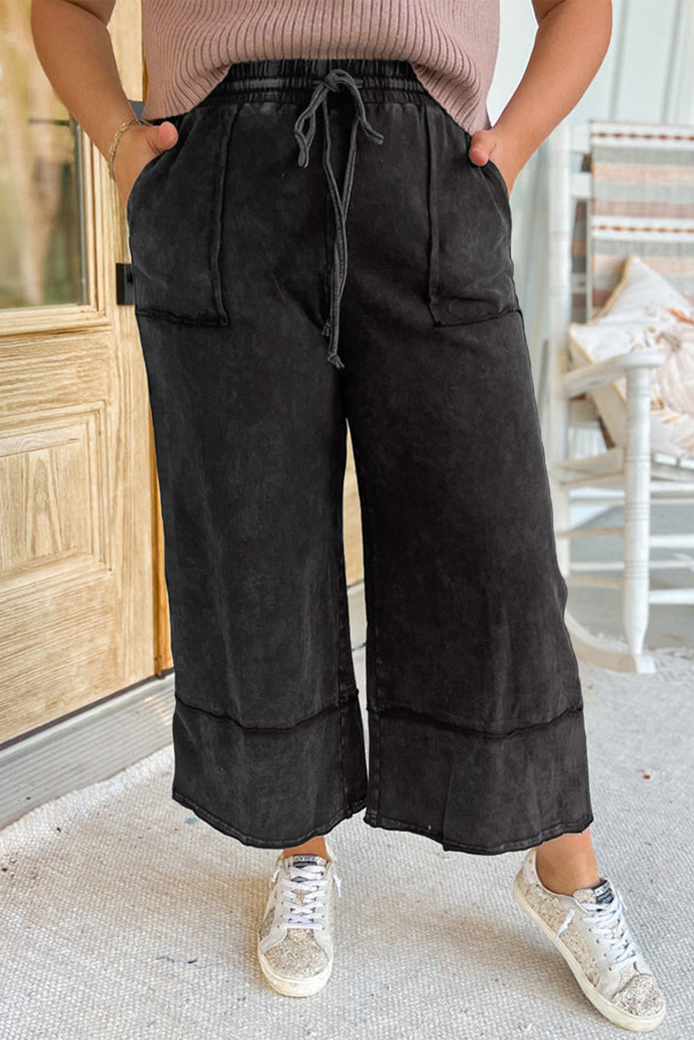 Chic black mineral wash wide leg cropped pants with exposed seams