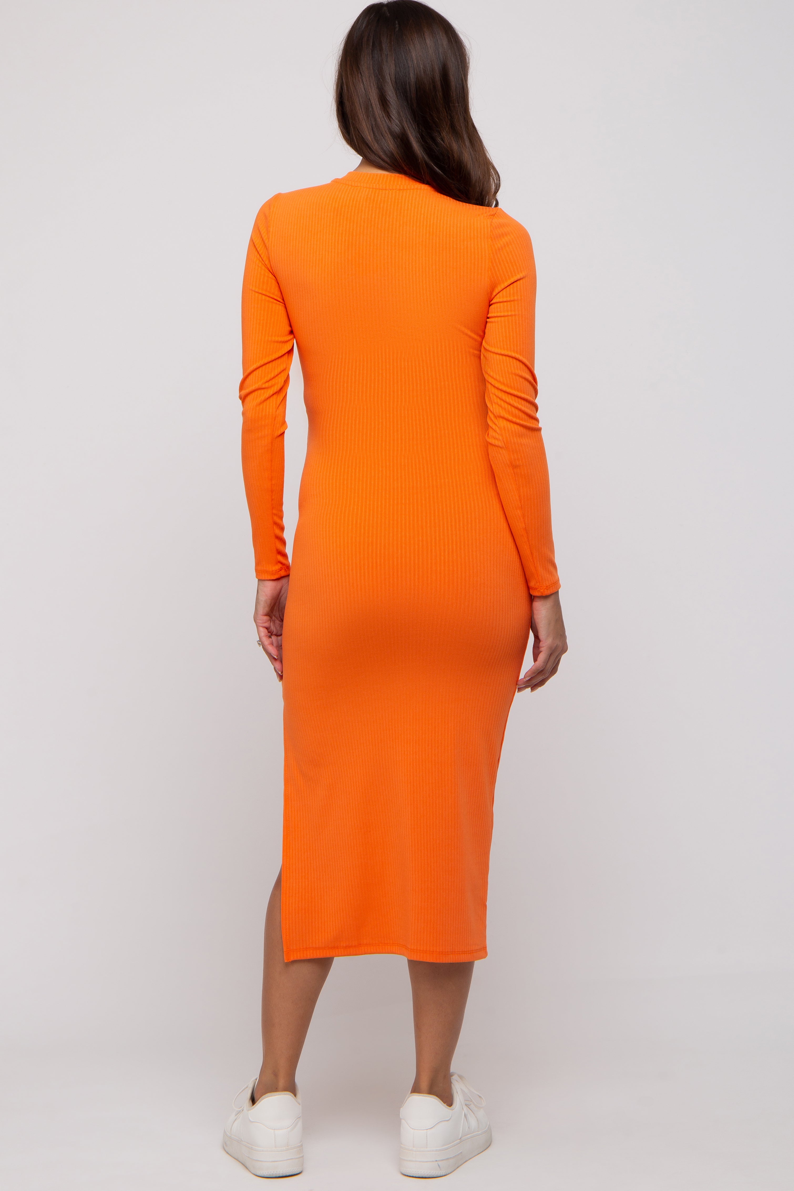 Close-up of the PinkBlush Orange Ribbed Mock Neck Maternity Dress fabric, detailing the comfortable stretch and quality knit.