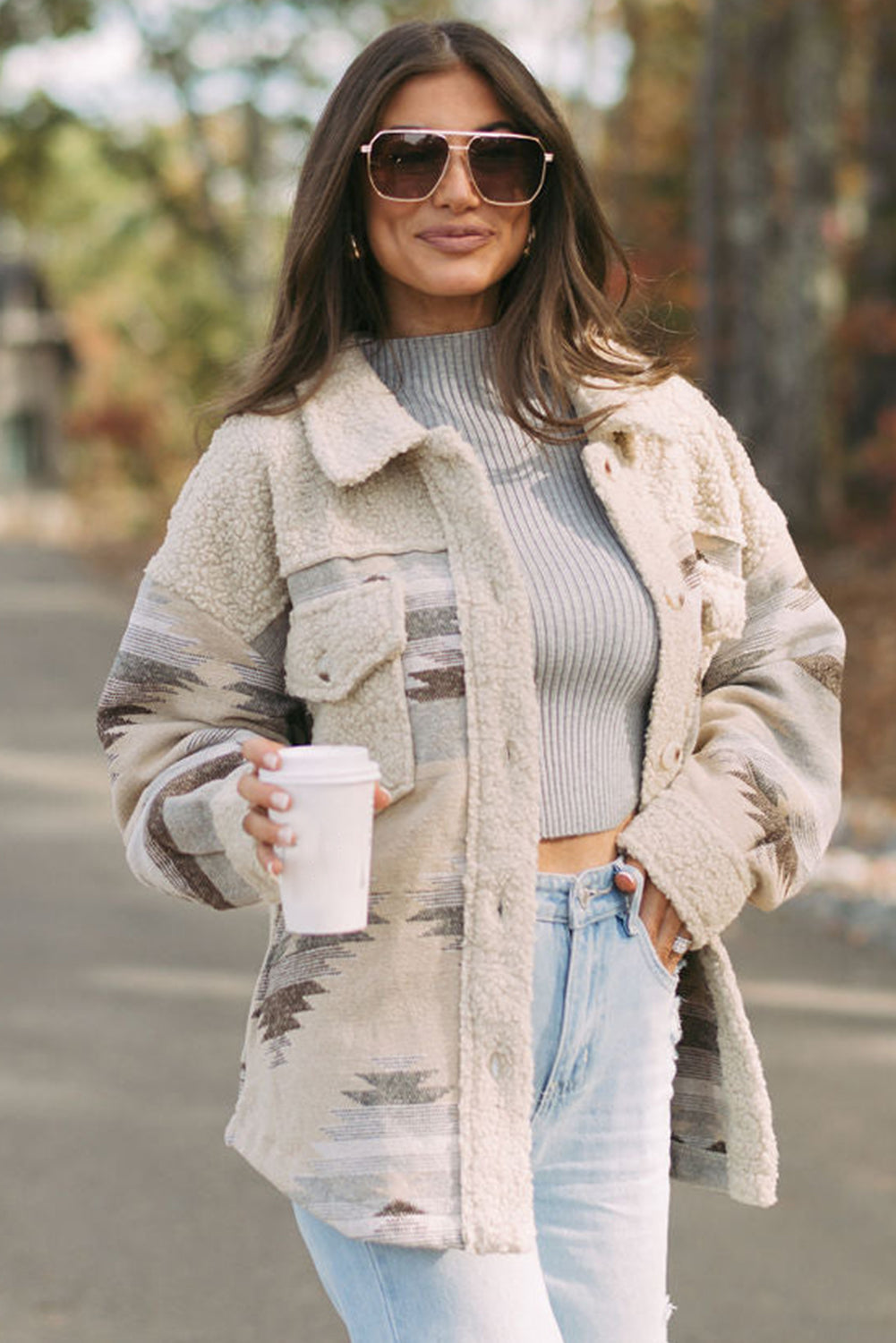 Khaki sherpa coat with vibrant Aztec print and flap pockets