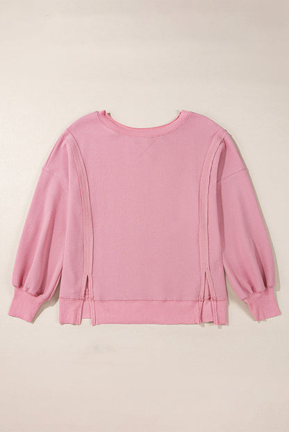 Cozy pink oversized sweatshirt with bishop sleeves and split detail