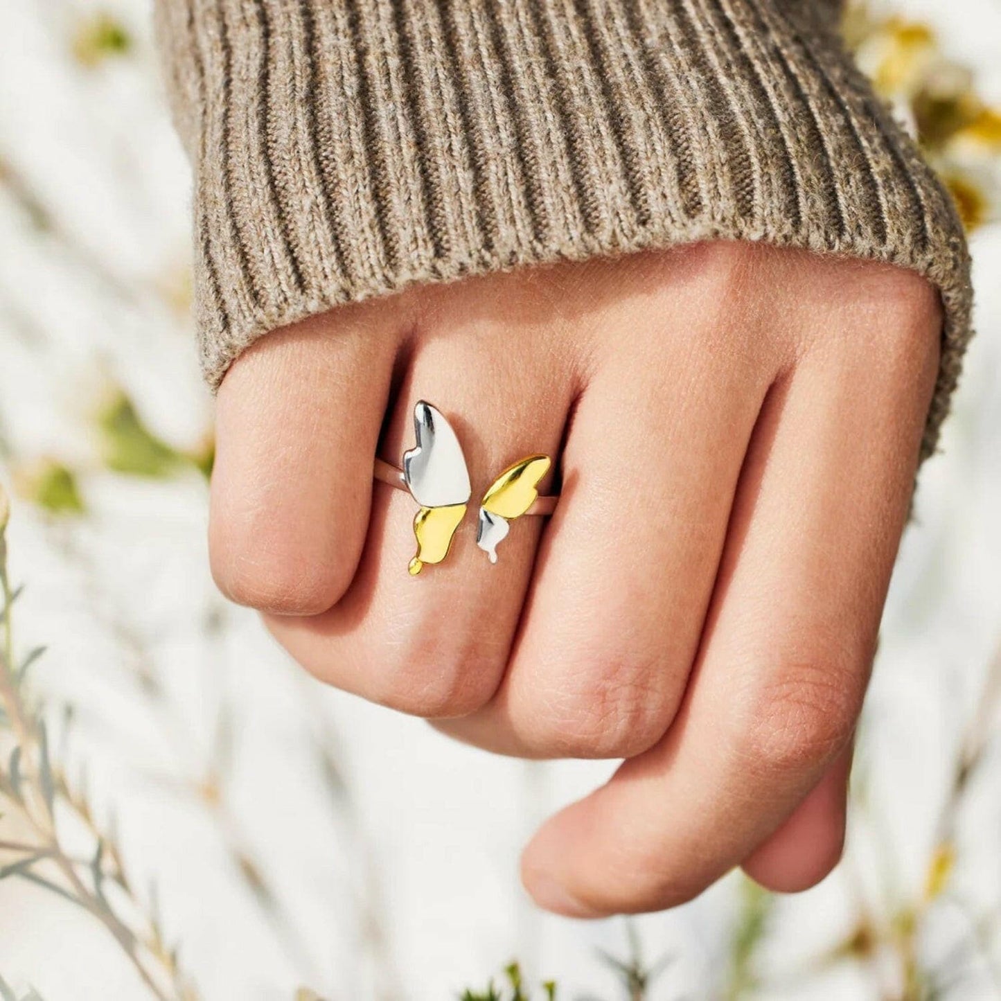 Butterfly dreams adjustable ring in sterling silver with a butterfly design on a finger.