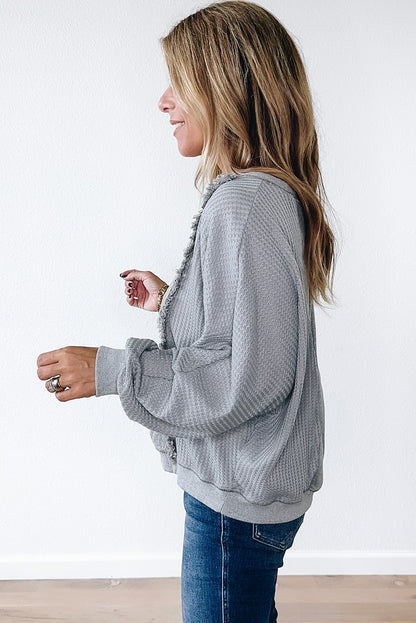 Chic light grey waffle patchwork pullover with raw hem details