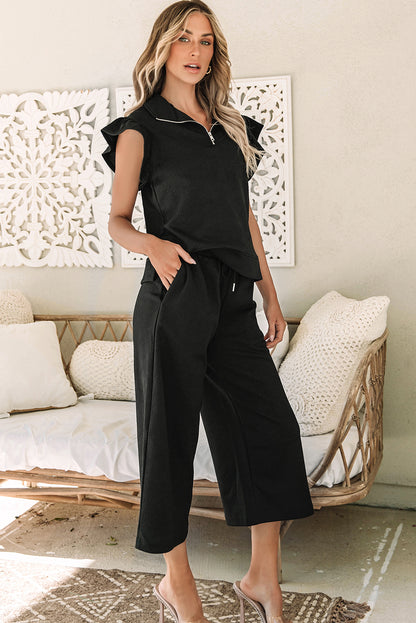 Chic black flutter sleeve top and wide-leg pants ensemble