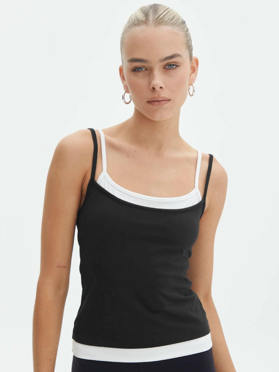 Faux layered square neck cropped cami in black with dual straps.