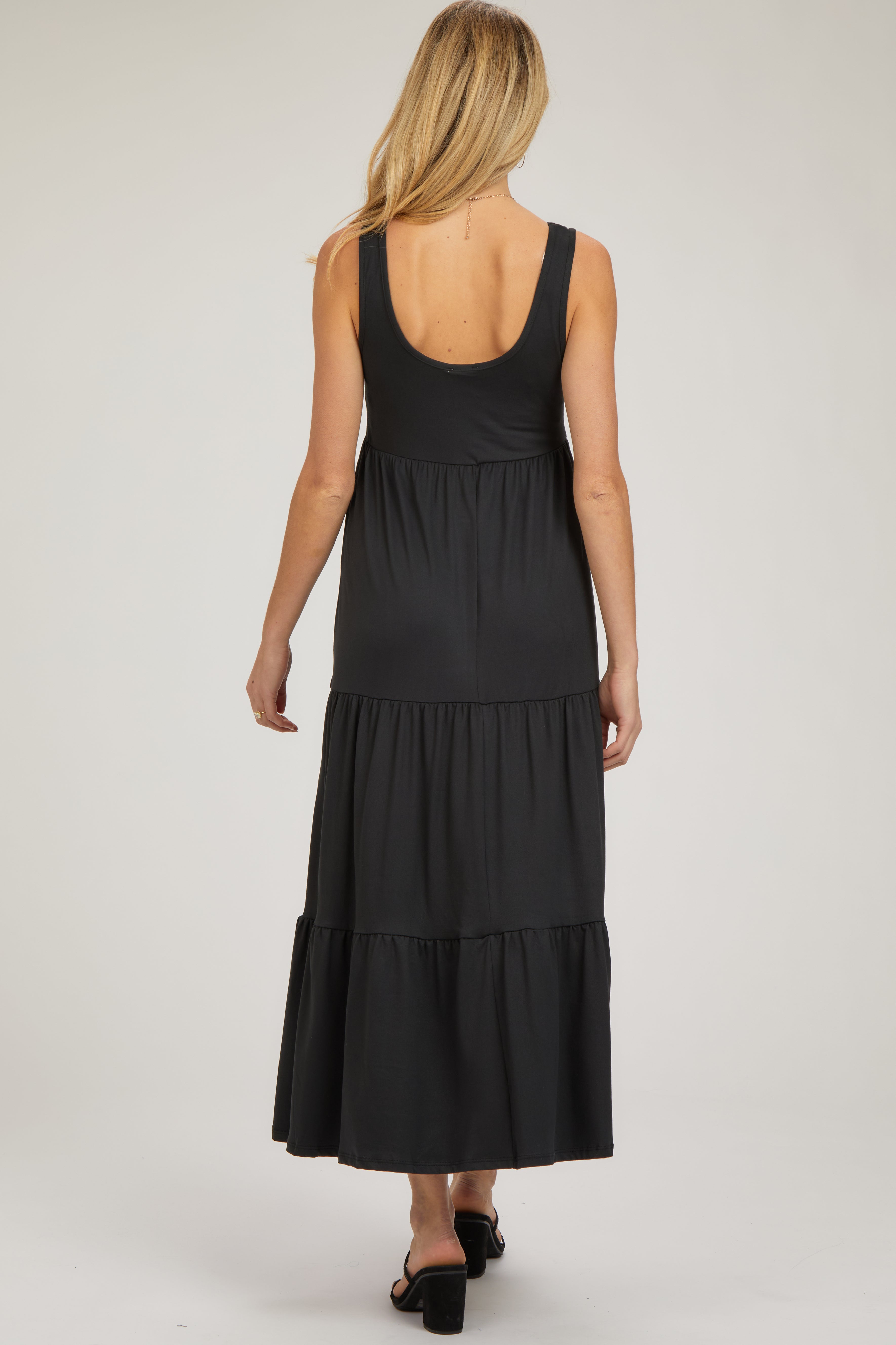 PinkBlush Black Tiered Maternity Maxi Dress, a close-up of the soft fabric and elegant tiered skirt design.