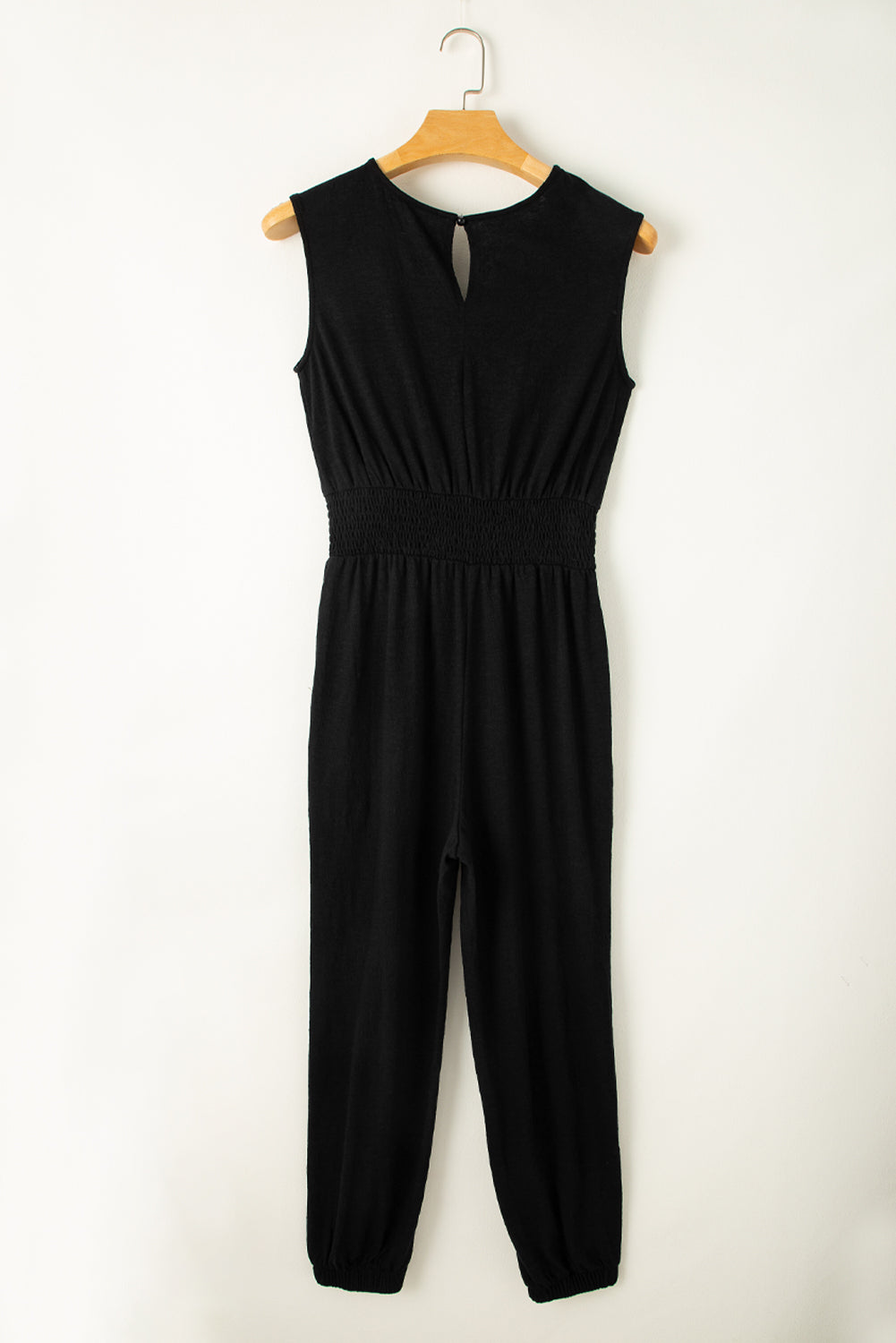 Sleek black sleeveless jumpsuit with v-neck and shirred design