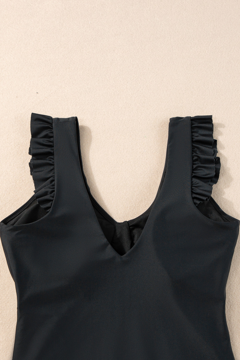 Chic black ruffled one-piece swimsuit with ruched details