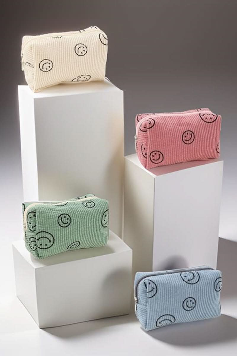 Zenana Smiley Face Corduroy Cosmetic Pouches in assorted colors on display.