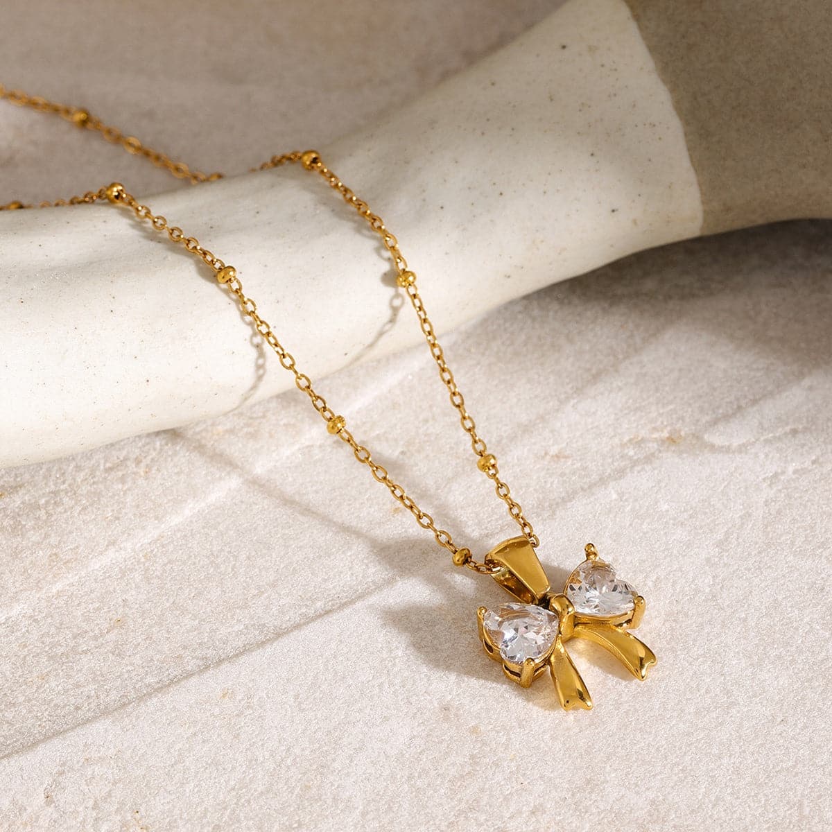 Elegant zircon and stainless steel bow necklace