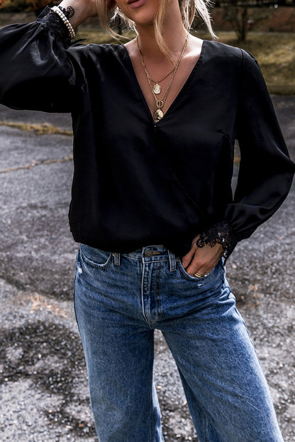 Elegant black lace V-neck blouse with crochet cuffs