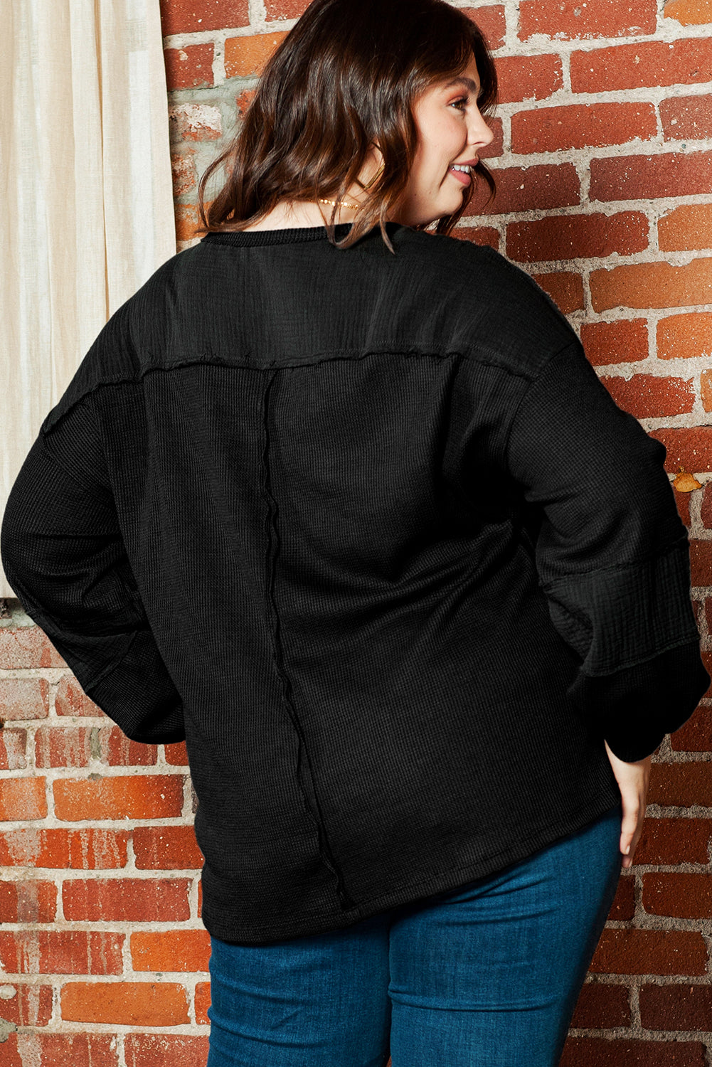 Chic black crinkle patchwork top in plus sizes with exposed seams