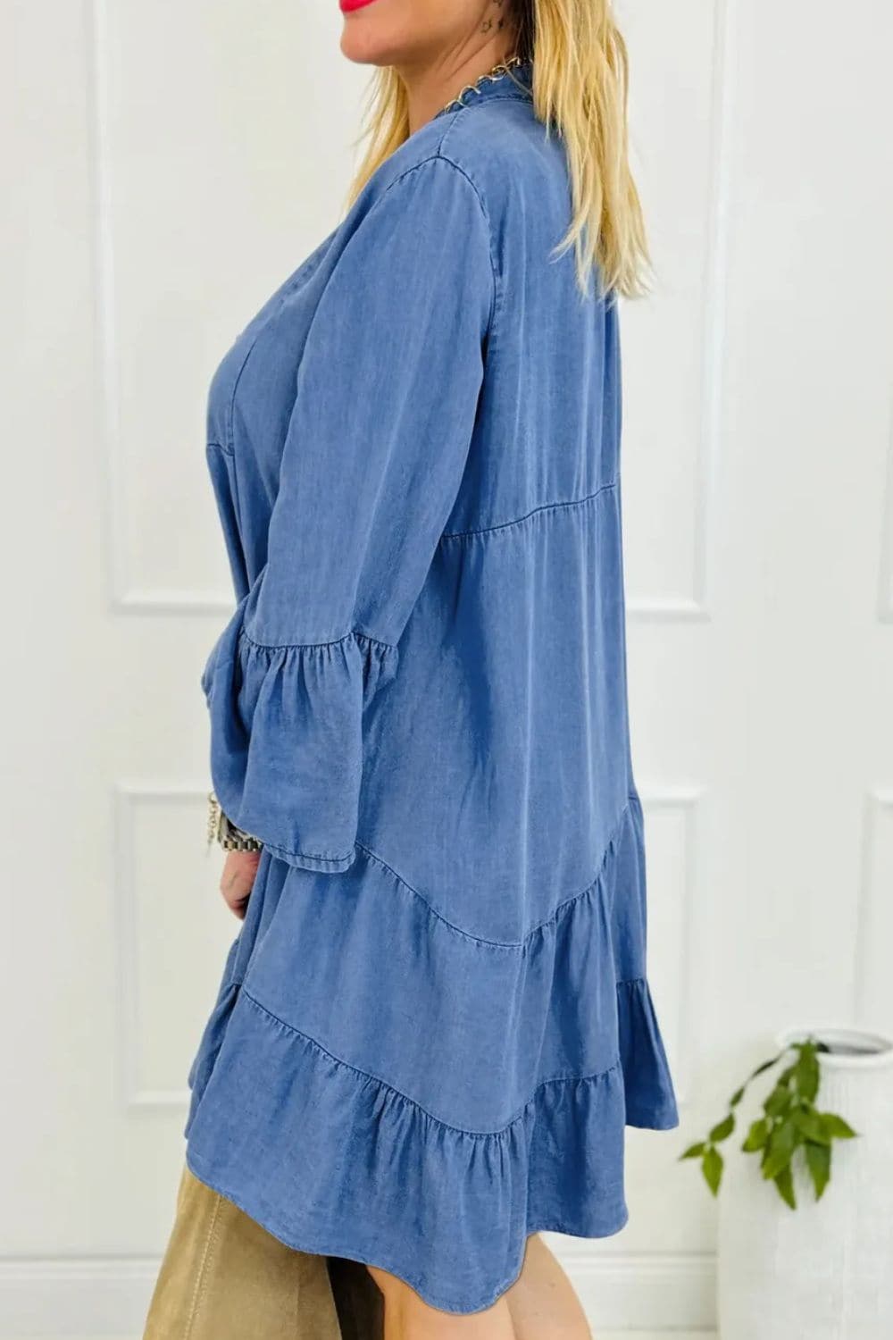 Trendy denim dress with ruffled sleeves and notched flare design.