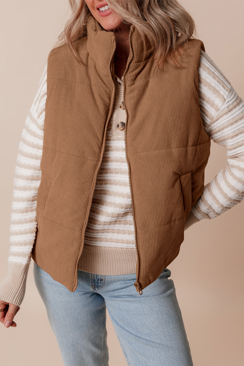 Cozy coffee corduroy vest with stand neck, zipper closure, and puffer style.