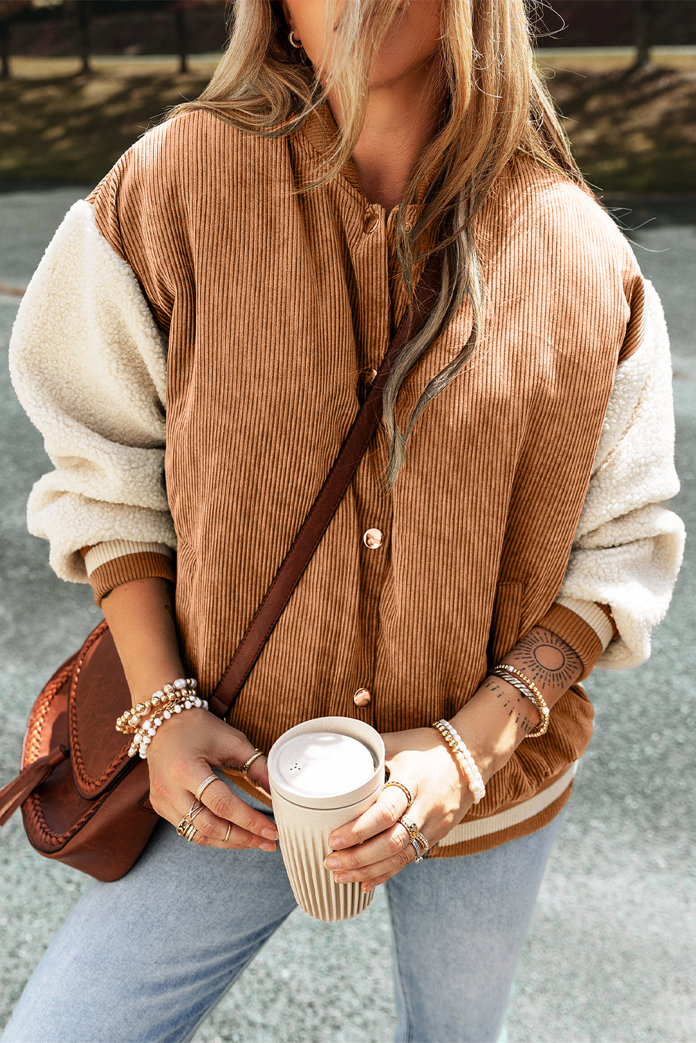 Buckskin corduroy fleece bomber with faux shearling sleeves, flat collar, and snap button front.