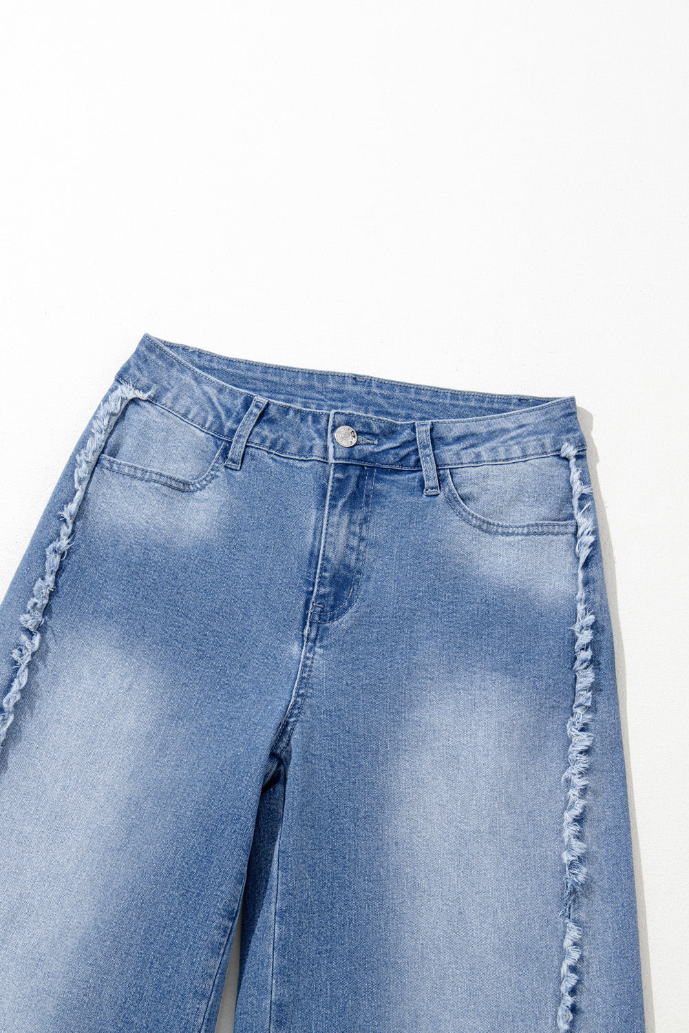 Vintage-inspired Beau Blue flared jeans with raw hem detailing