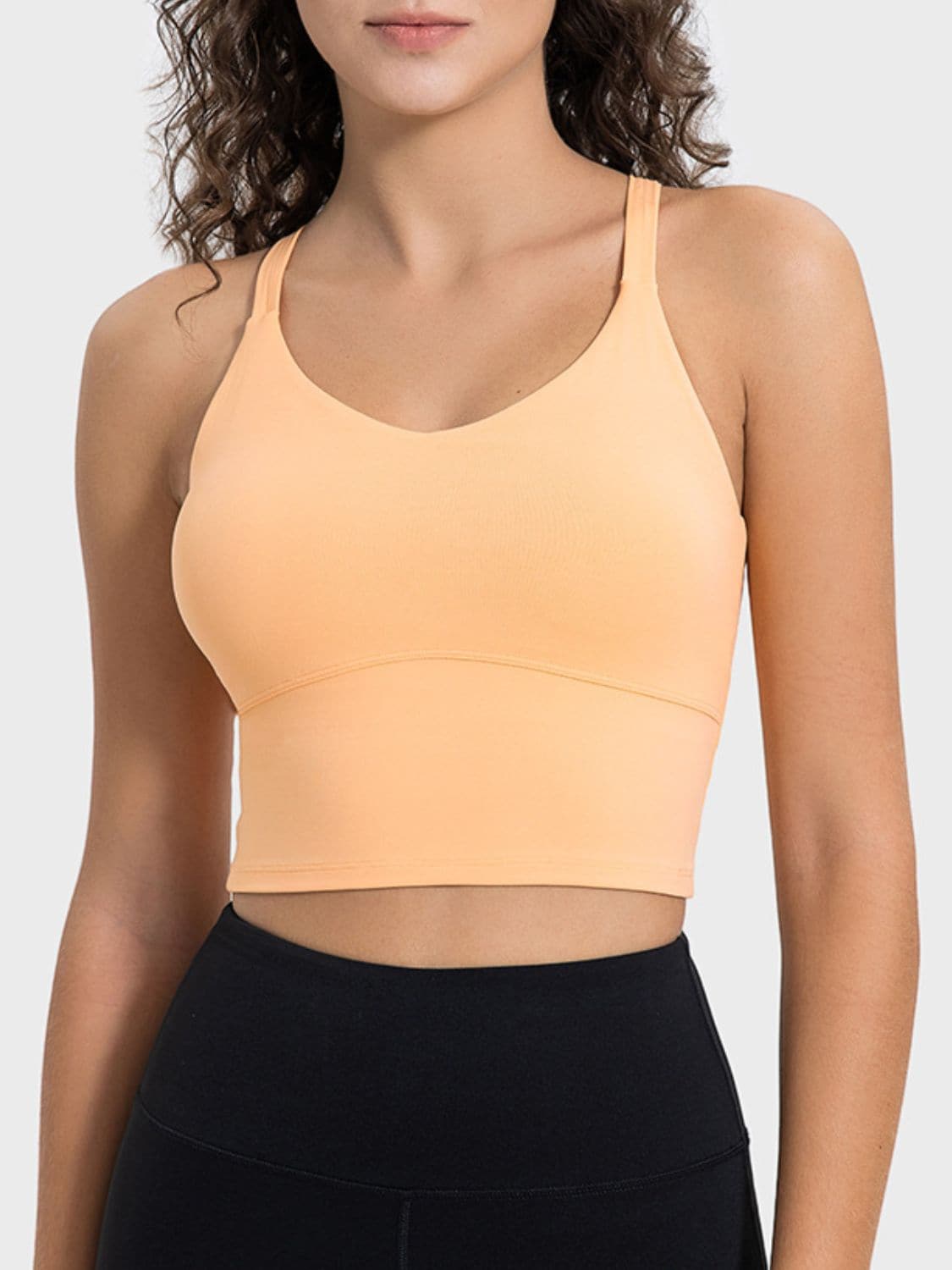 Crisscross sheer active tank top in peach, featuring trendy crisscross design and comfortable stretch fabric.