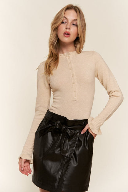 Elevate your wardrobe with the chic half-button long sleeve bodysuit