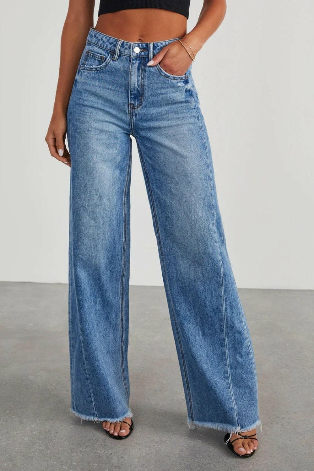 Raw hem wide leg jeans with pockets and button closure.