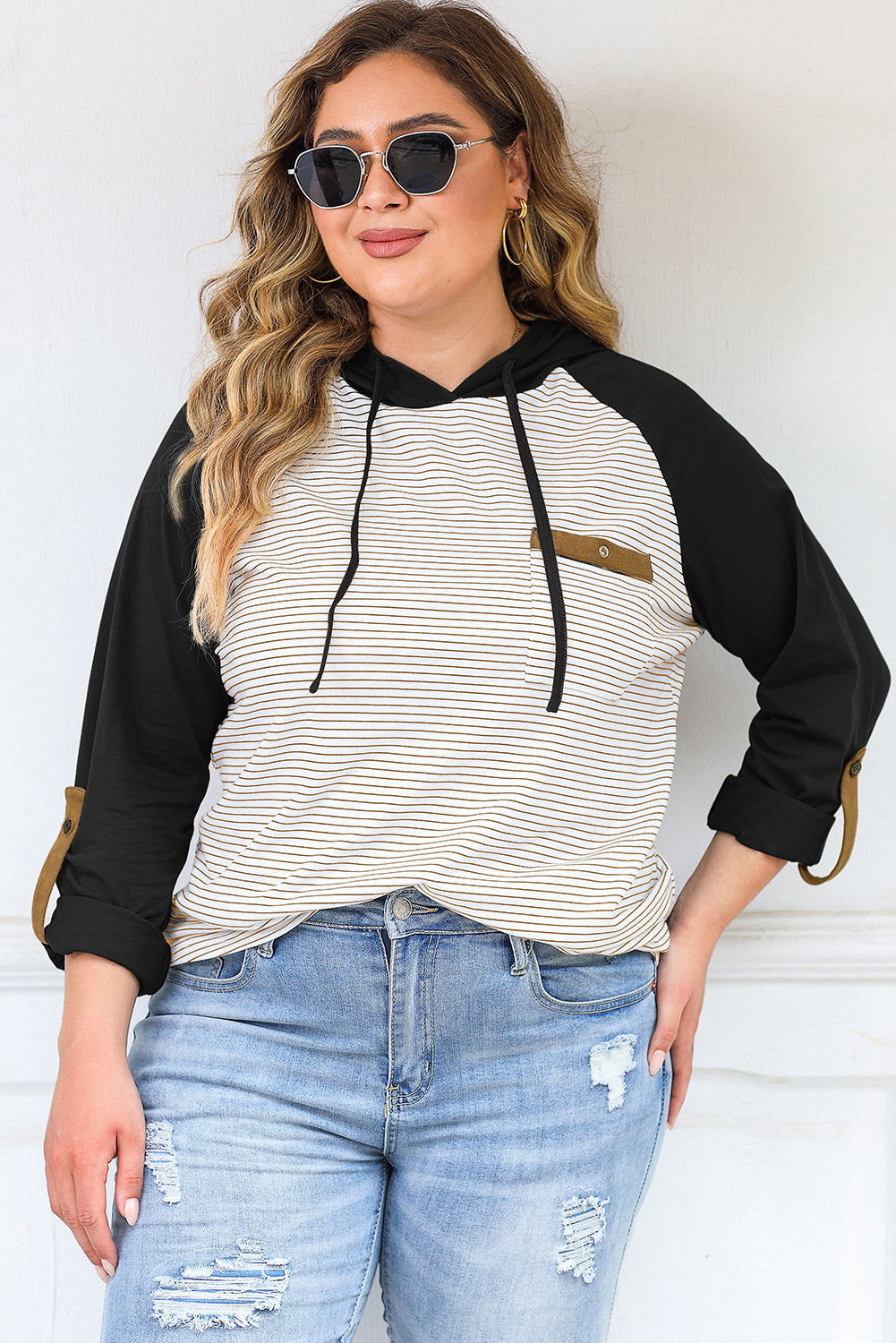 Plus size black and white striped hoodie with raglan sleeves and button pocket