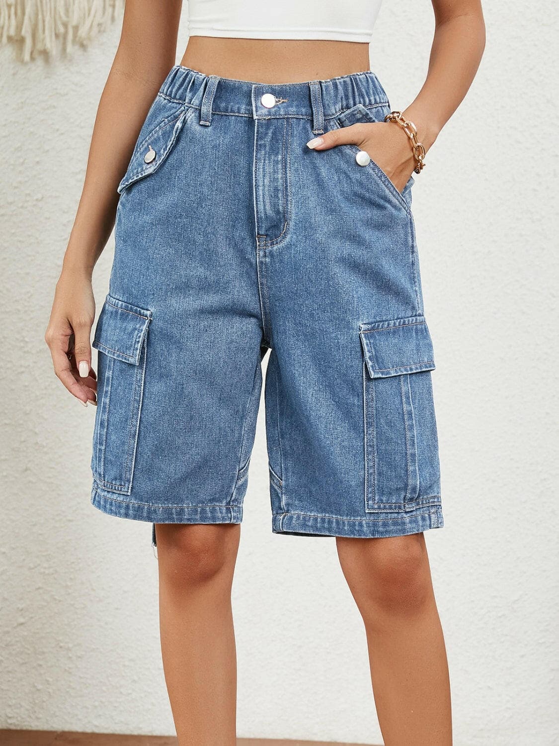 Buttoned elastic waist denim shorts with pockets for summer comfort and style.