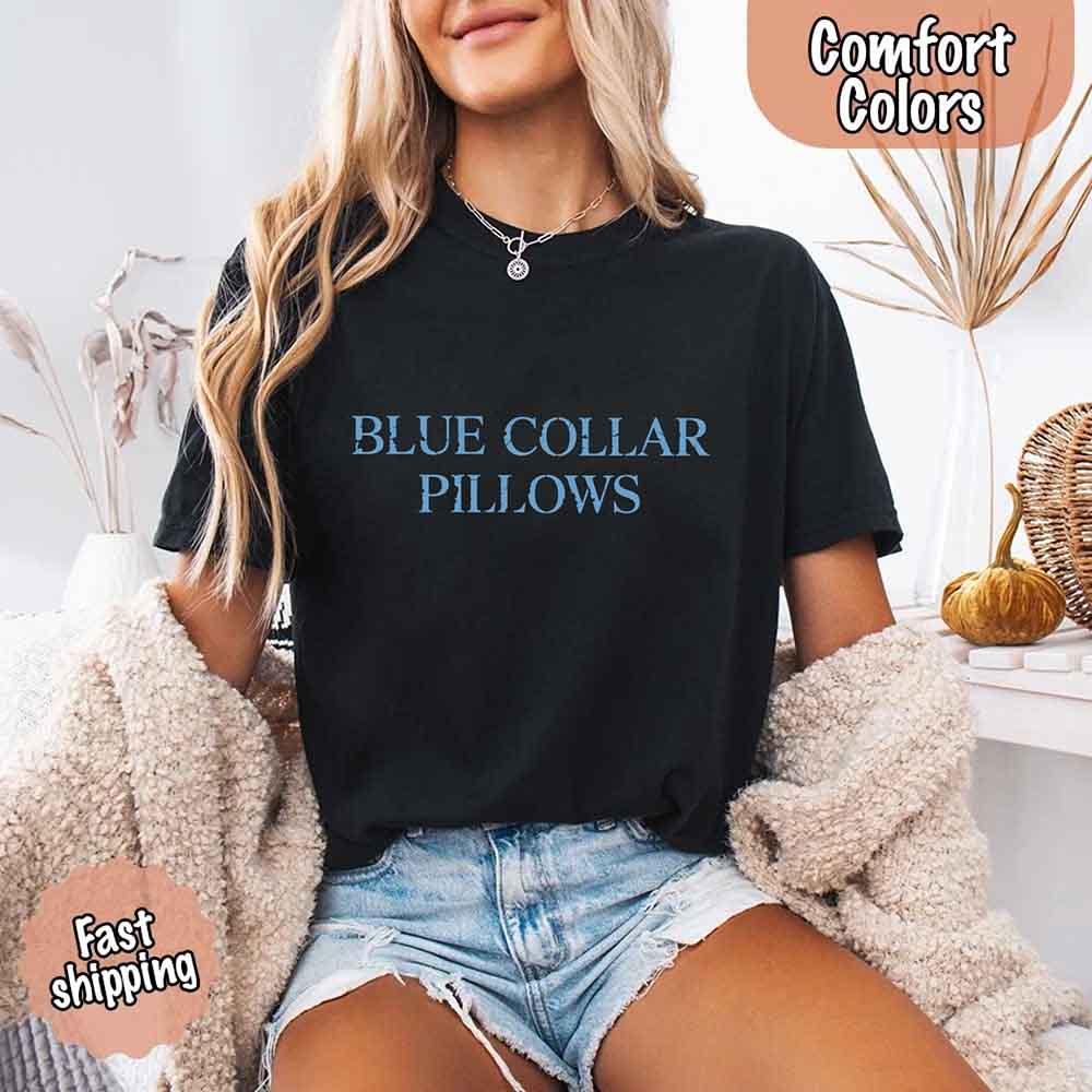 Adorb Custom Tees Blue Collar Wife Comfort Colors Tee. A woman wears the funny graphic shirt in a soft, vintage-style fabric.