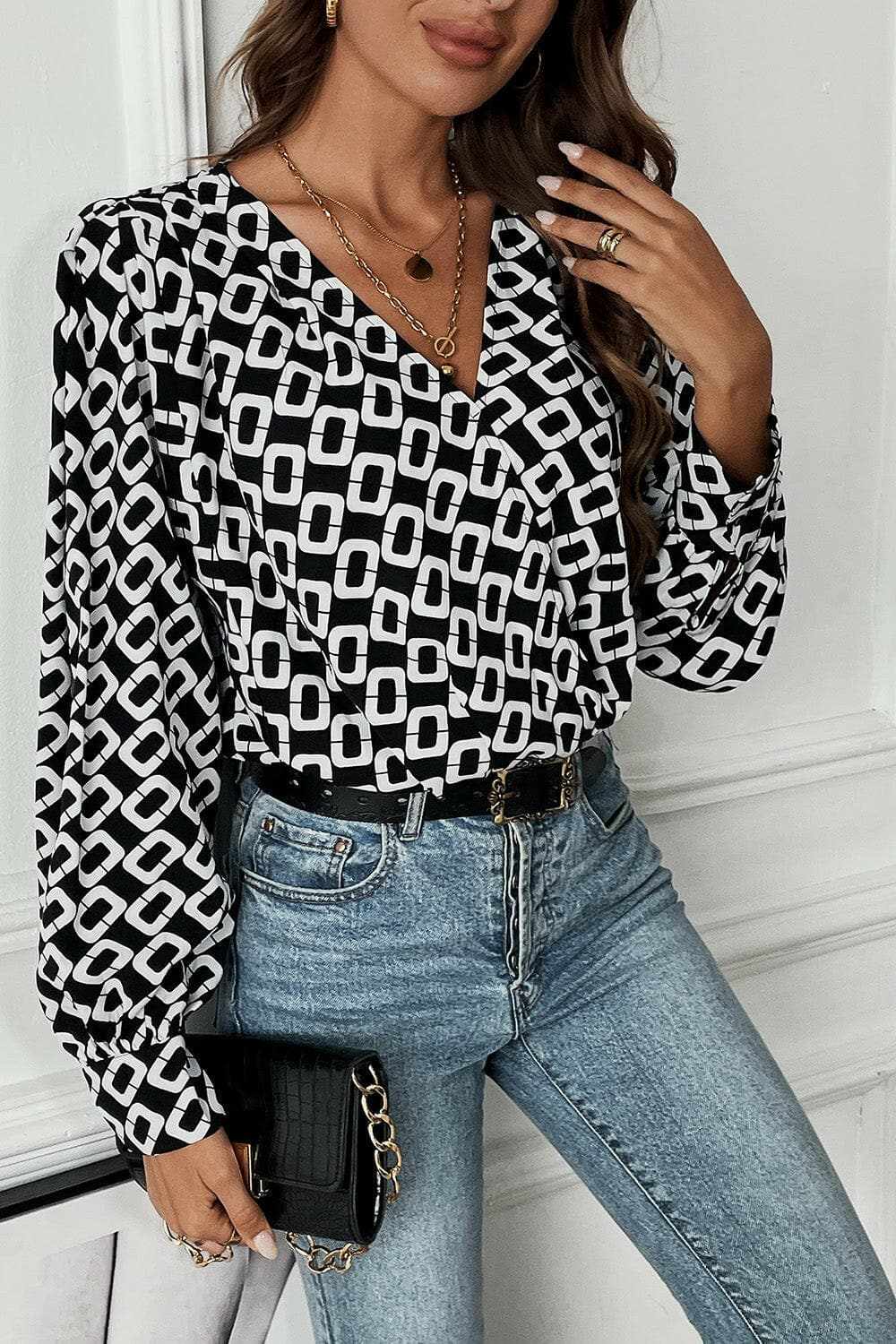 Chic geometric v-neck long sleeve blouse with modern pattern.