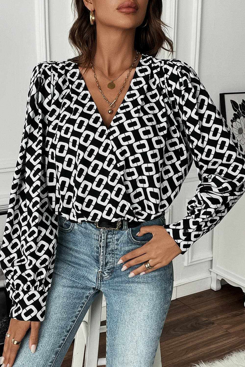 Chic geometric v-neck long sleeve blouse with modern pattern and comfortable fit.