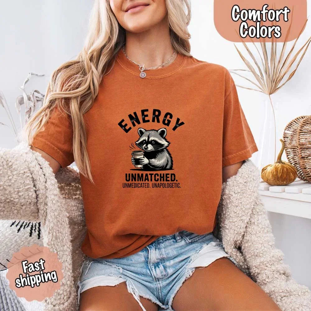 Adorb Custom Tees funny Raccoon Coffee T-Shirt, a lifestyle shot showing its versatility for everyday wear by a coffee lover.
