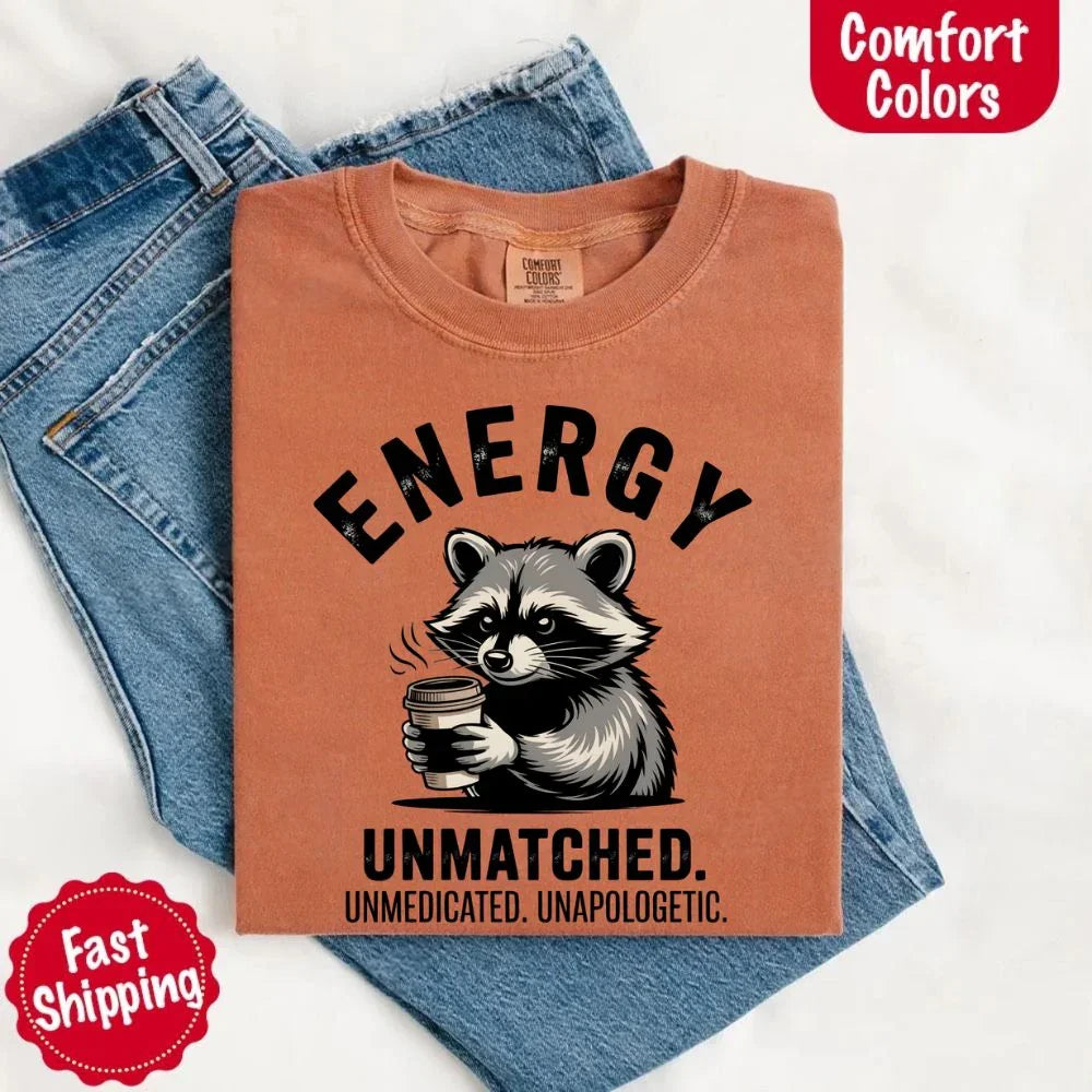 Adorb Custom Tees Comfort Colors Energy Unmatched Raccoon Coffee T-Shirt, a close-up of the collar and tag details.