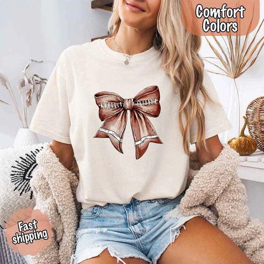 Adorb Custom Tees' Vintage Football Bow T-Shirt on a soft Comfort Colors tee, a cute game day essential for women.