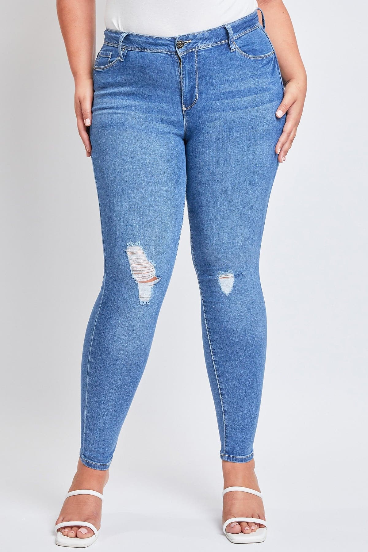 Model wearing YMI JEANS Women's Plus Sustainable Distressed Skinny Jeans, showing their comfortable, flexible fit.