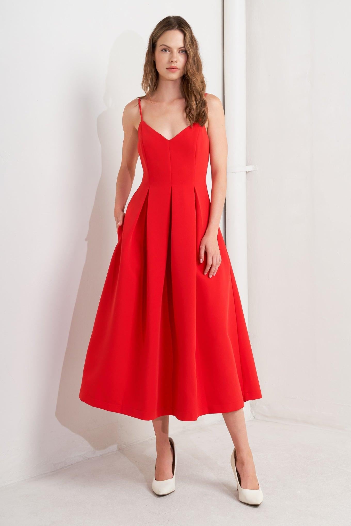 Detail shot of the Flying Tomato Ruby Affair Woven Midi Dress, focusing on the elegant midi length hemline and flattering drape.