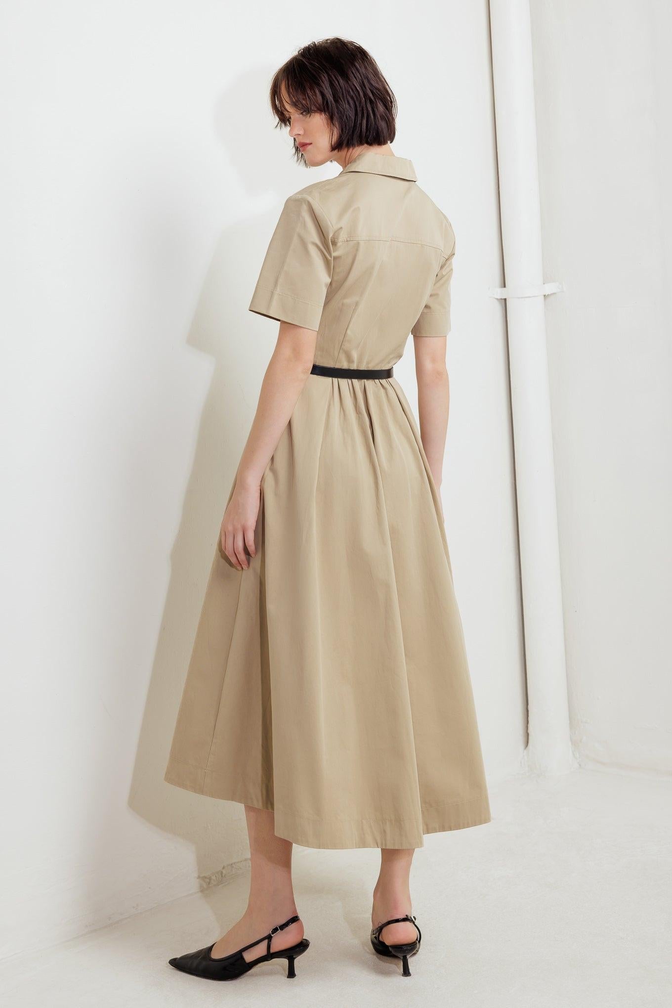 Close-up detail of the Flying Tomato Quiet Romance Tan Woven Midi Dress, showcasing the intricate woven fabric texture and soft tan hue.