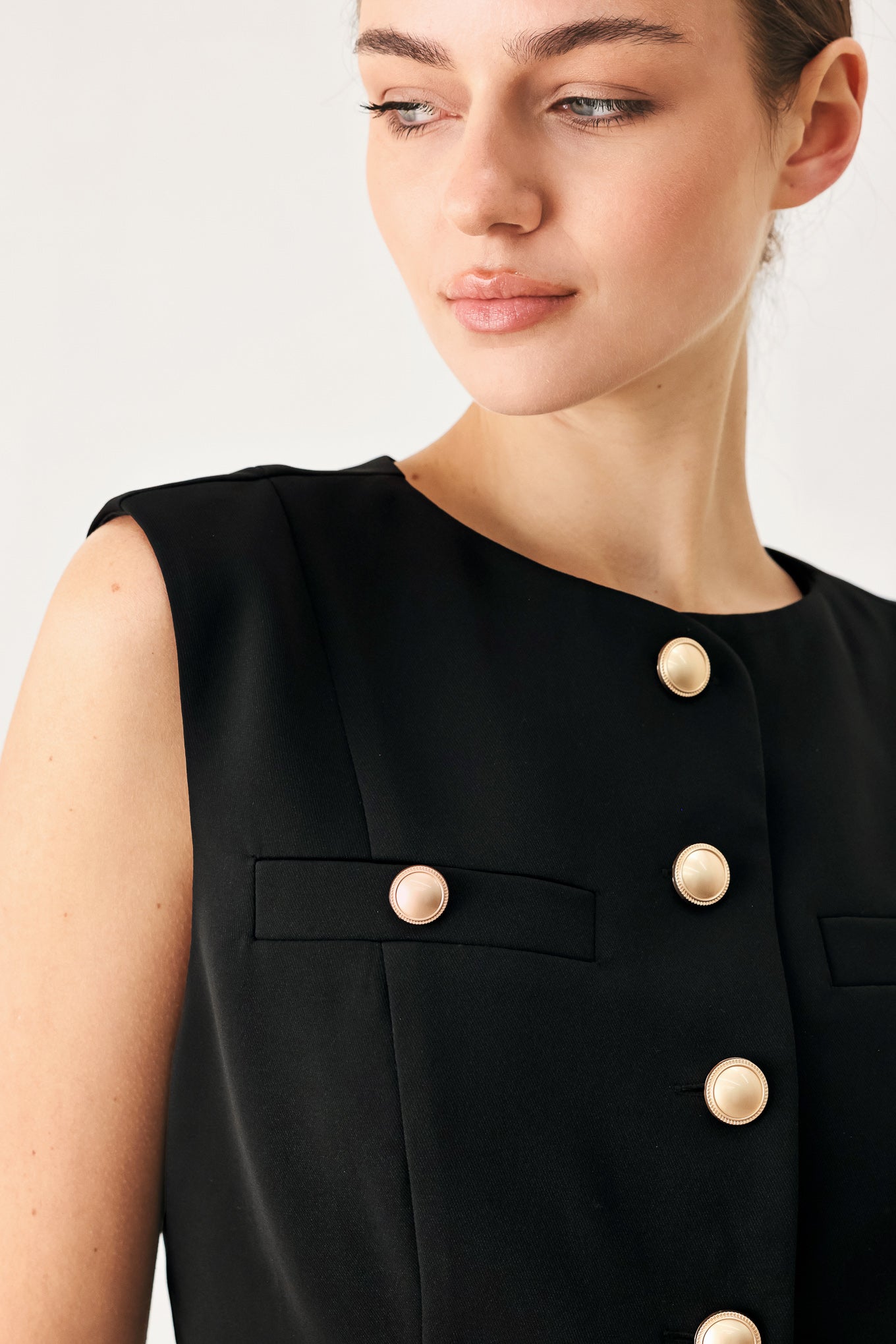 Black Sleeveless Woven Vest With Button Front And Round Neckline