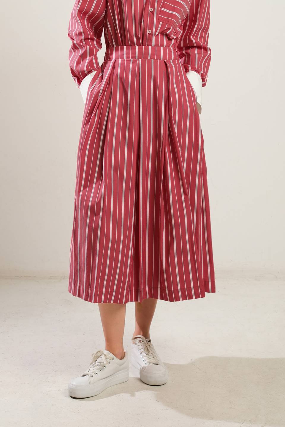 Striped red woven midi skirt with side zipper; features a relaxed fit for versatile styling.