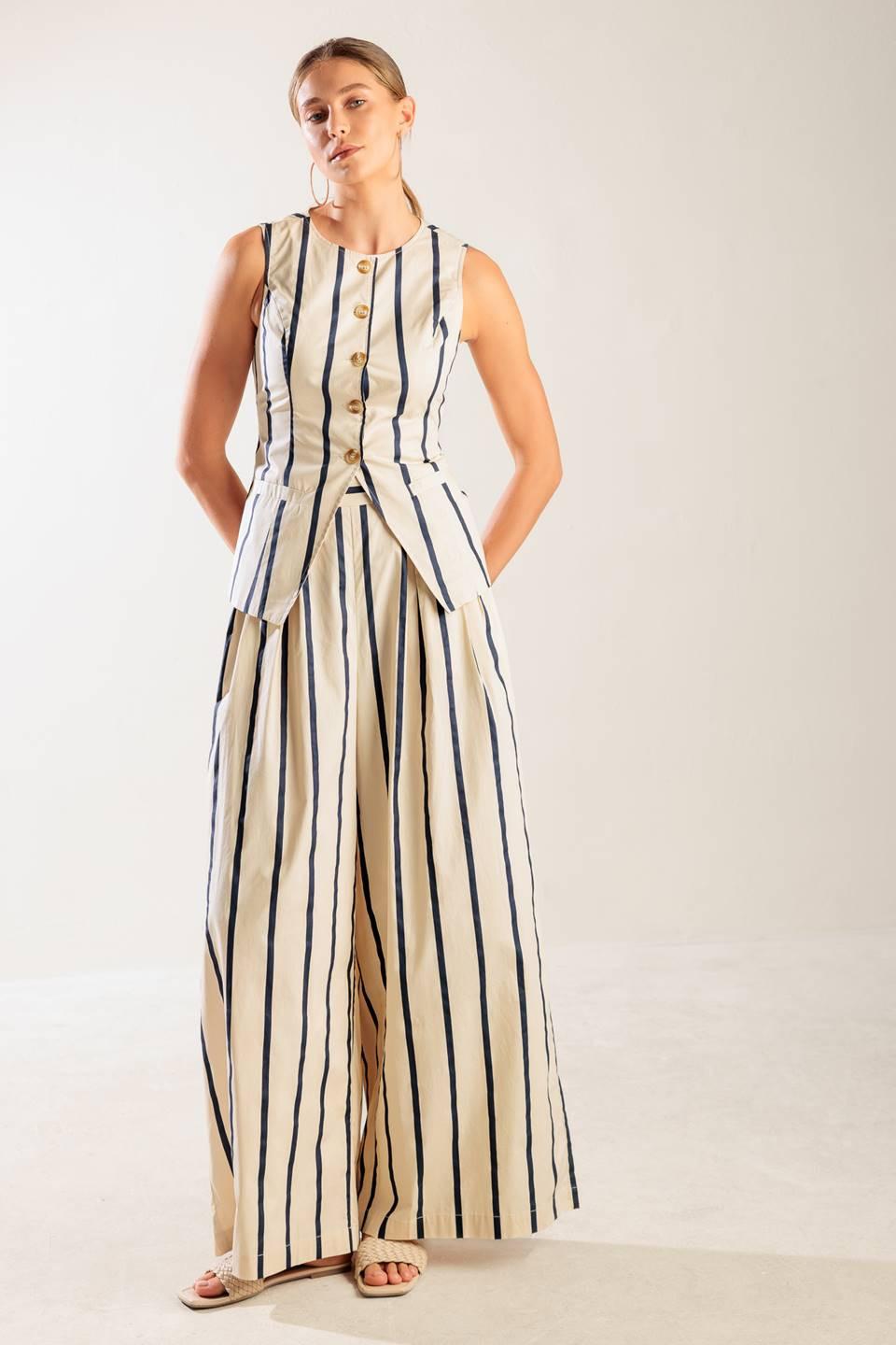 Flying Tomato HERE AND NOW WOVEN PANTS in a seated pose, demonstrating the comfortable stretch and elegant drape of the fabri